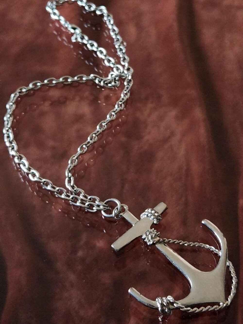 Silver anchor pendant necklace with rope detail.